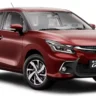 Toyota Glanza 2025 hatchback in red color featuring sleek LED headlamps, bold grille, and alloy wheels – premium, fuel-efficient car with 22.9 kmpl mileage in India